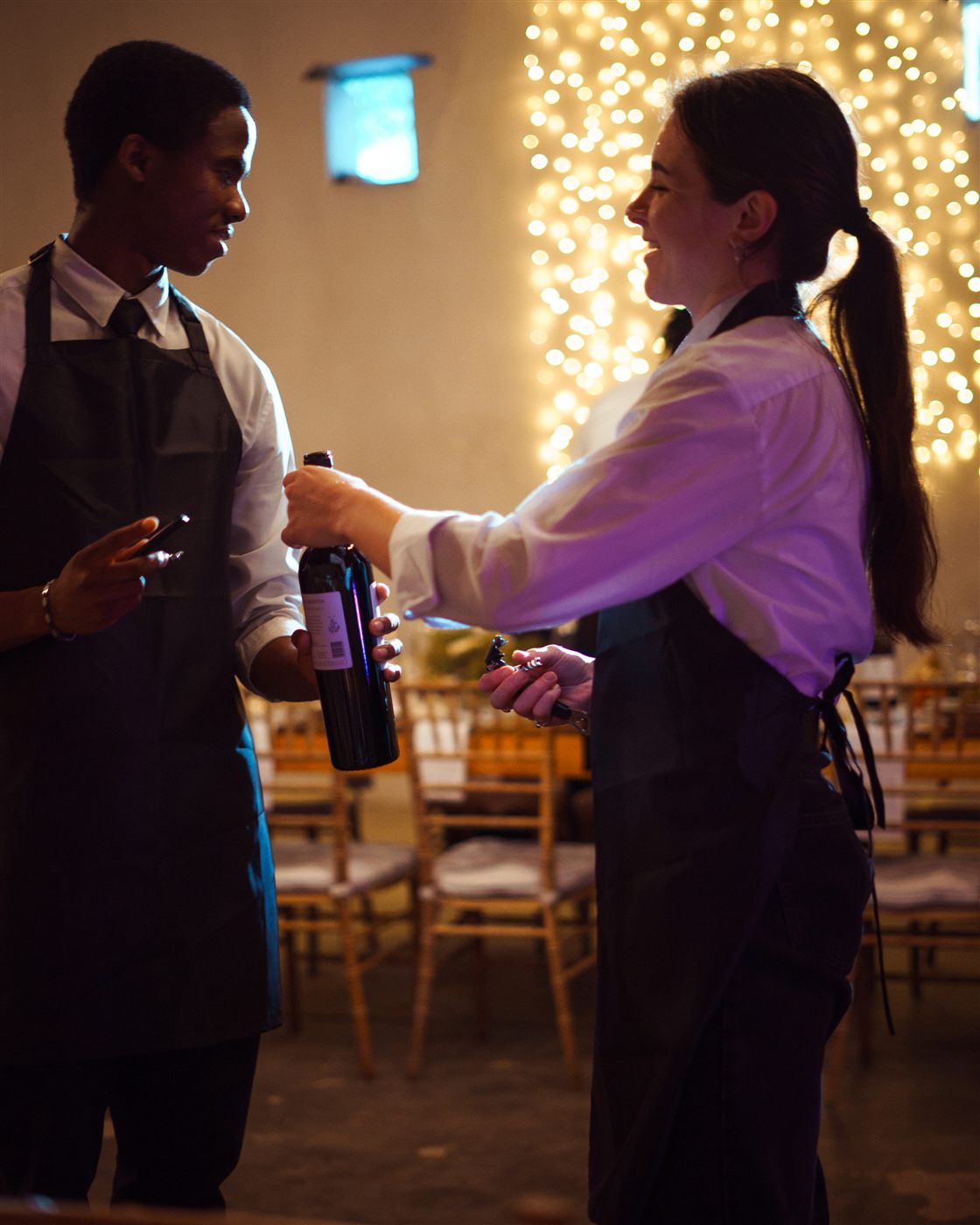 Silver Service waitron opening wine at a Cape Town wedding