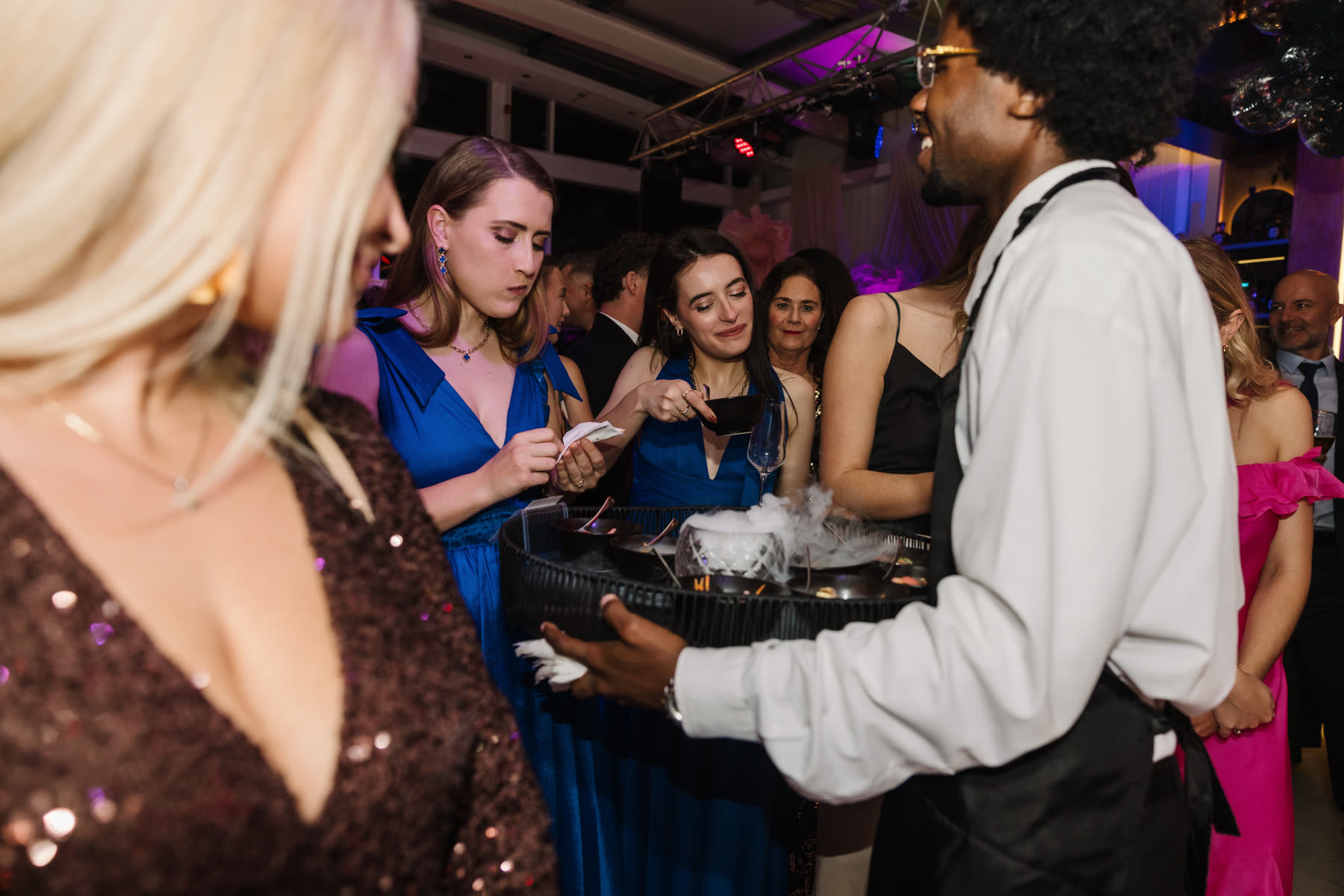 Waitron circulating a canapé tray among guests